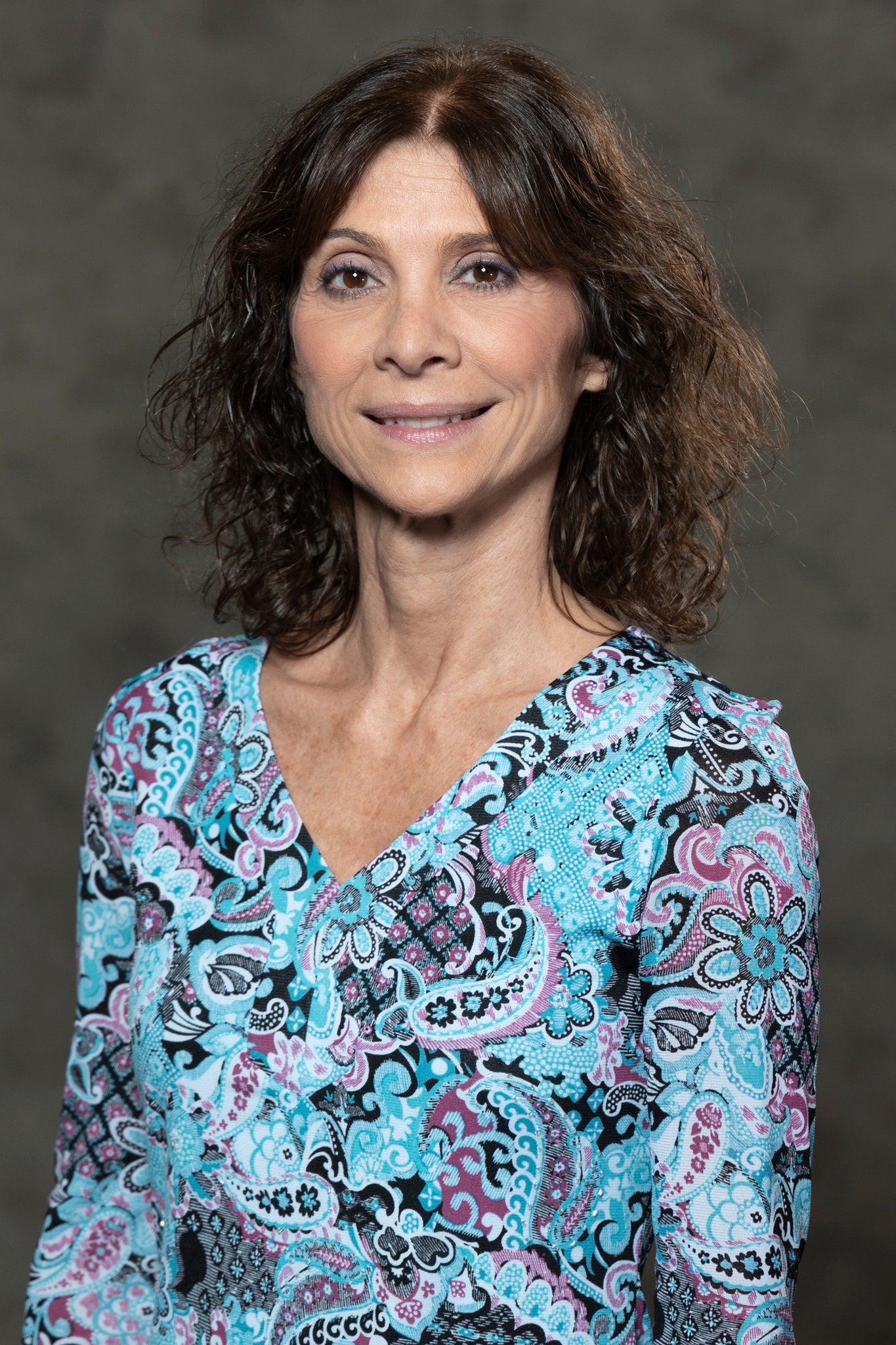 Picture of Caucasian woman who is smiling and wearing a black top